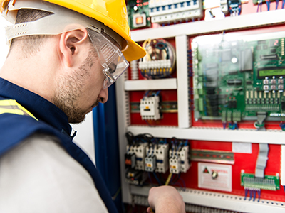 Electrical Contractors - BMS Technician working on BMS system in Switchboard panel