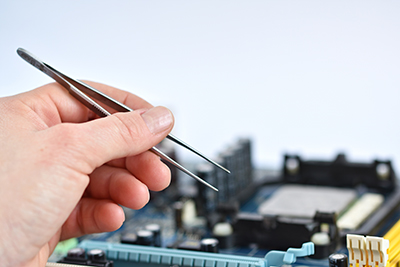 electronic printed circuit board being repaired