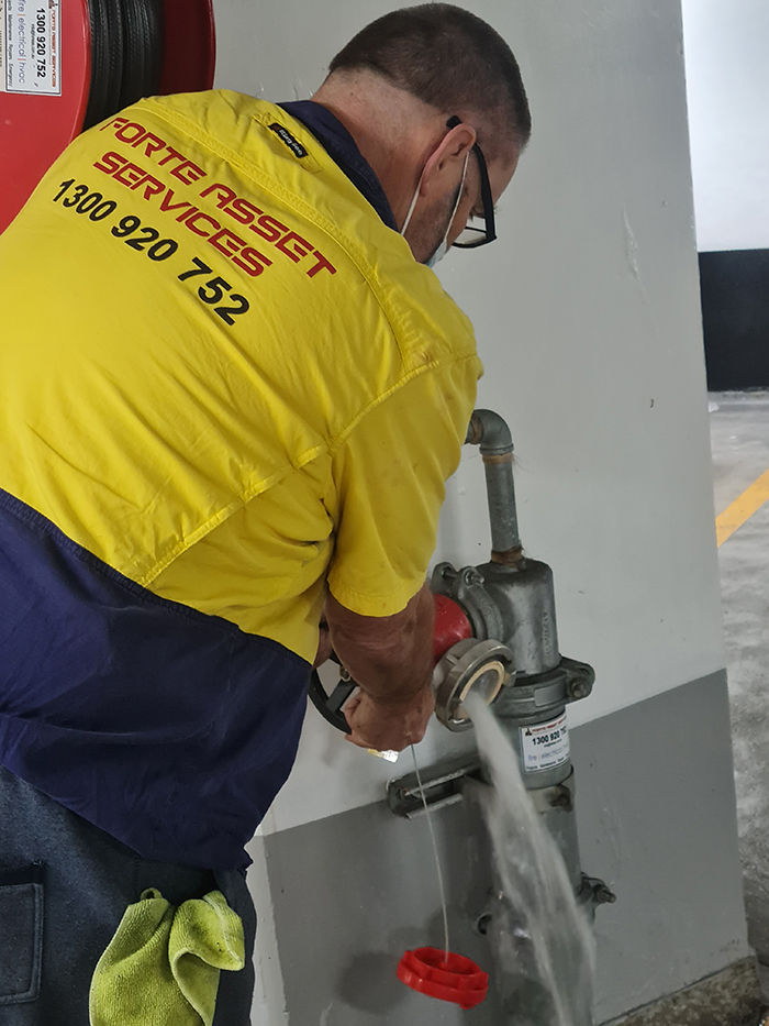 Forte Asset Services Fire Protection Technician testing and Maintaining a hydrant landing valve Sydney CBD Building