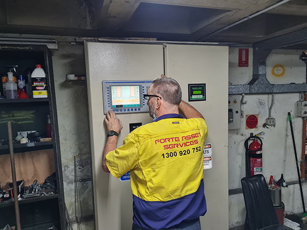 Forte Asset Services Technician working on a control panel serving mechanical services and electrical motors in Sydney CBD