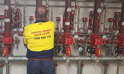 fire protection services technician inpsecting fire sprinkler system installation Sydney