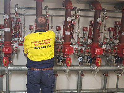 fire protection services technician inpsecting fire sprinkler system installation Sydney