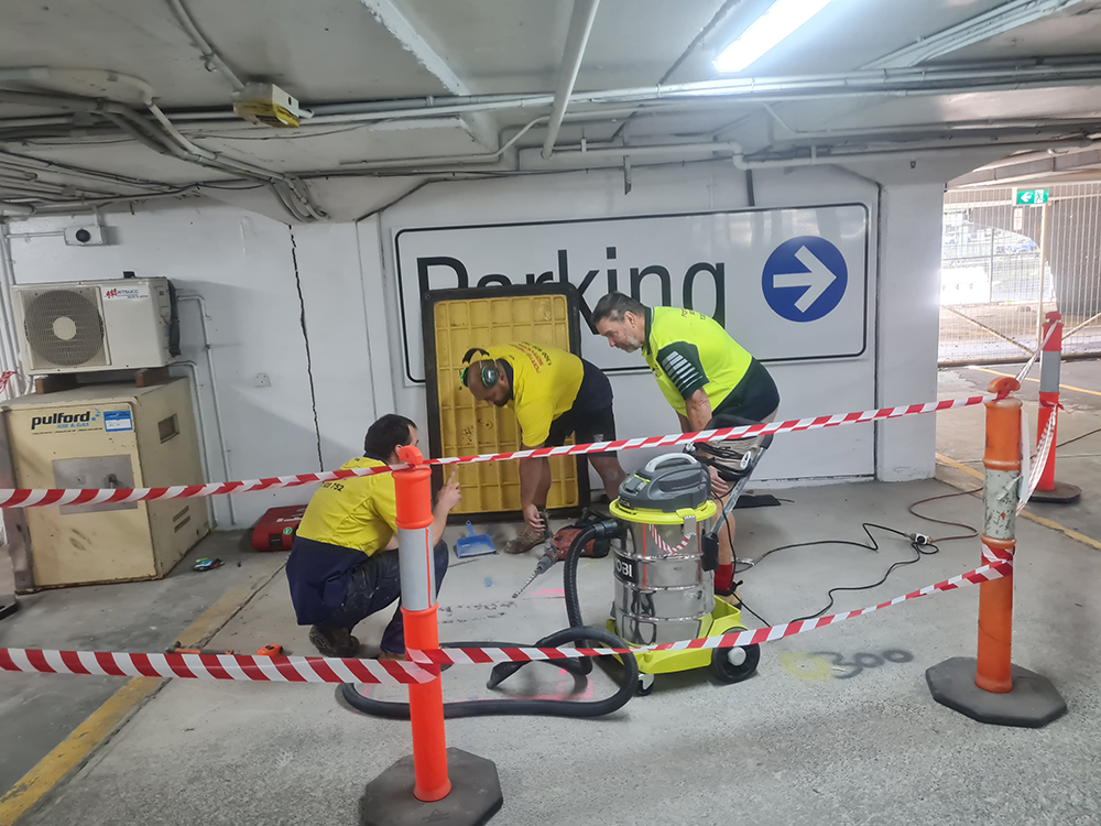 Commercial Property Asset Services Forte Technicans seeking a specific repair under the concret slab. All WHS protocols in place including flouro shirts, PPE, Boots, Area taped off etc - 