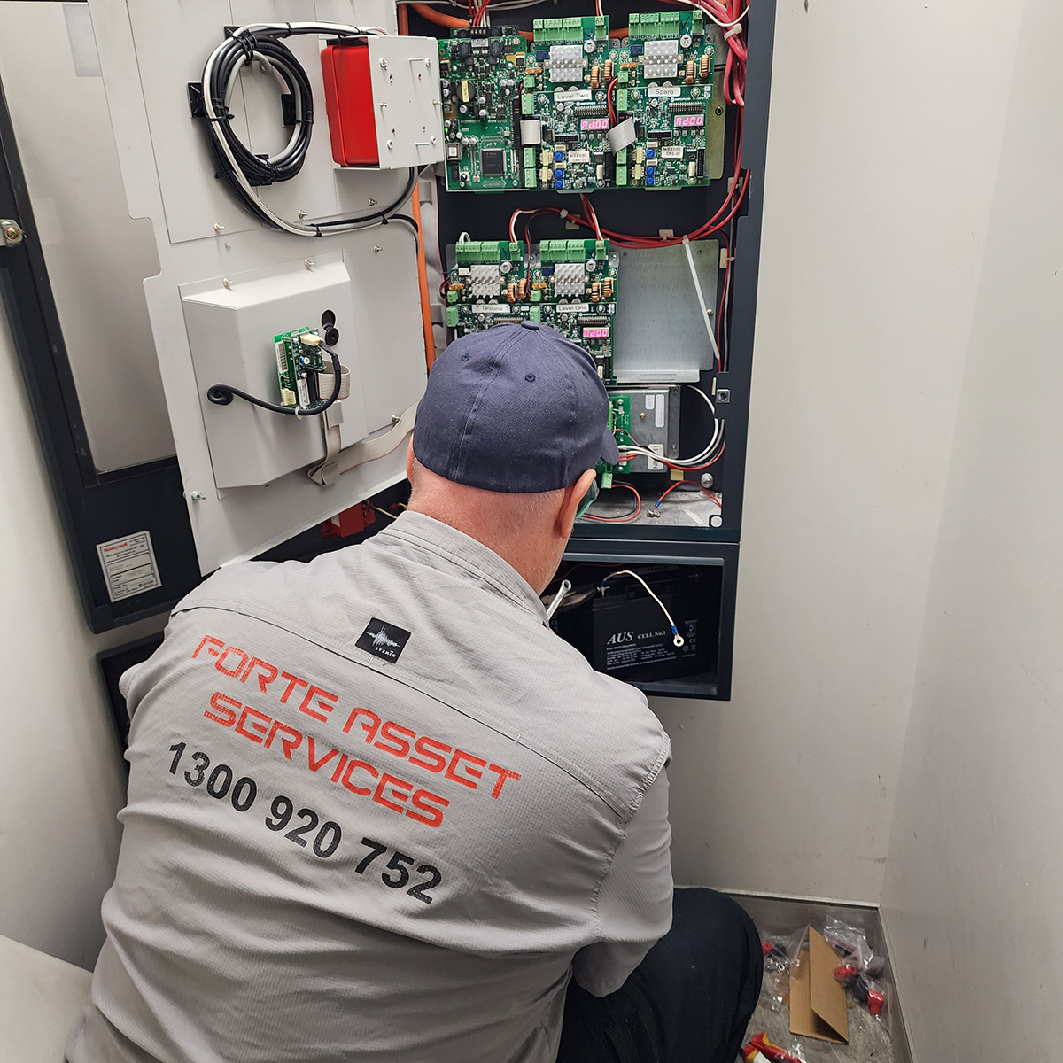 Forte Electrcian working on the installation of a ABB variable Speed Drive to servie the Cooling Tower fan in this residential Sydney Apartment complex